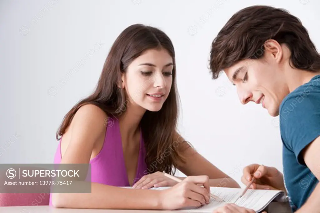 Two young friends studying together,