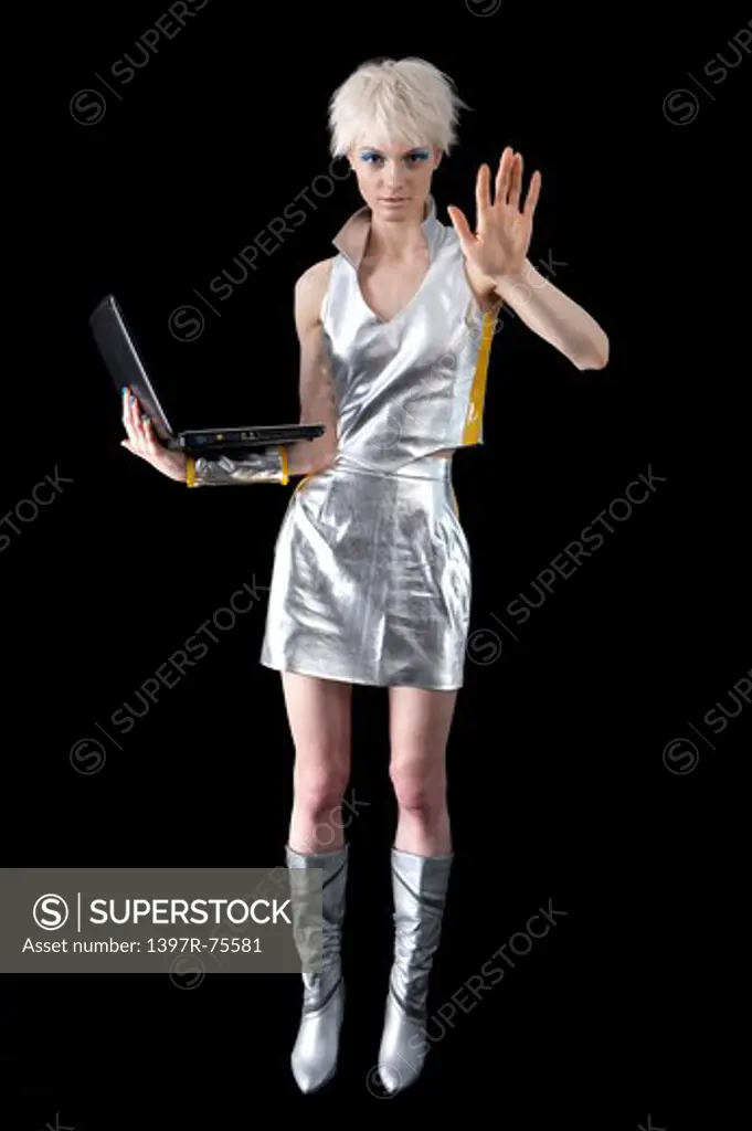 Young woman holding laptop and touching