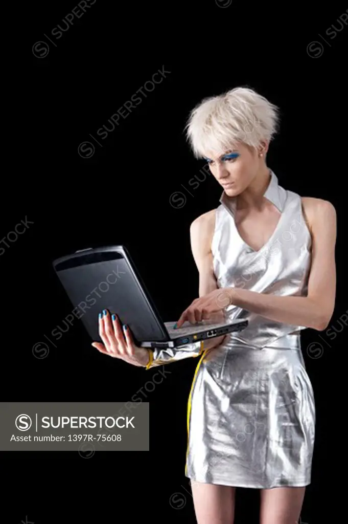Young woman using laptop and looking down