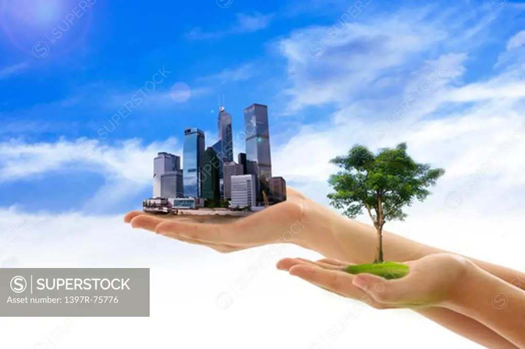 Environmental Conservation, Digitally generated image of human hands holding a tree and buildings with blue sky in background