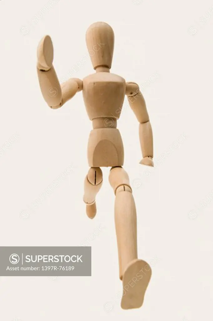 A wooden mannequin in gesture of running