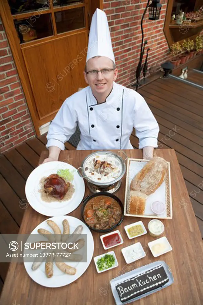 Chef with various kinds of German food, elevated view