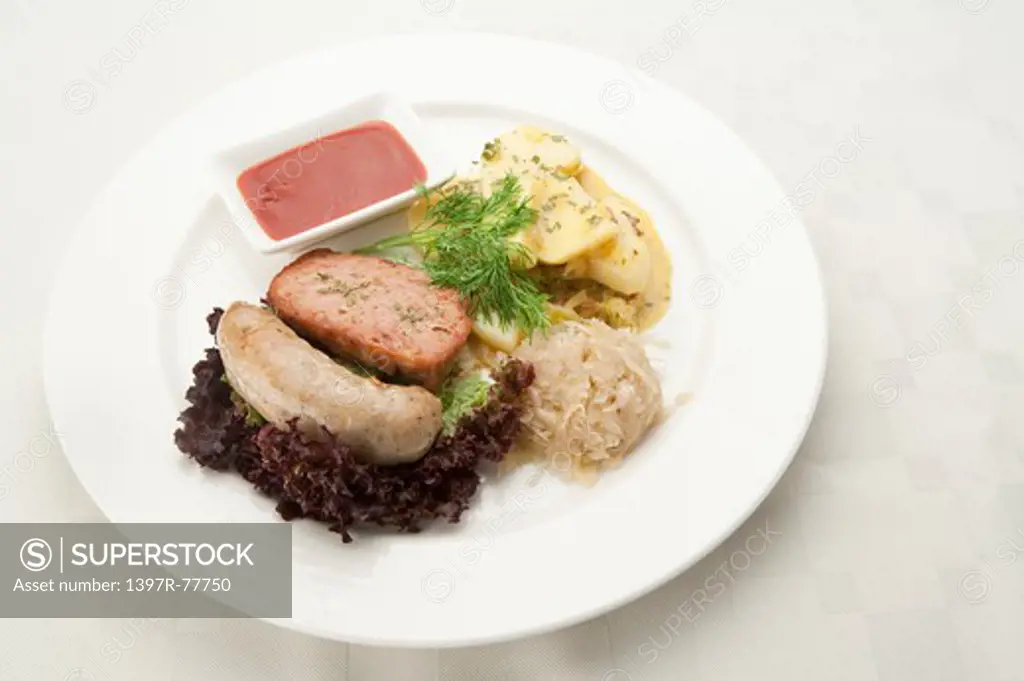 German sausage, tomato salad and sauerkraut