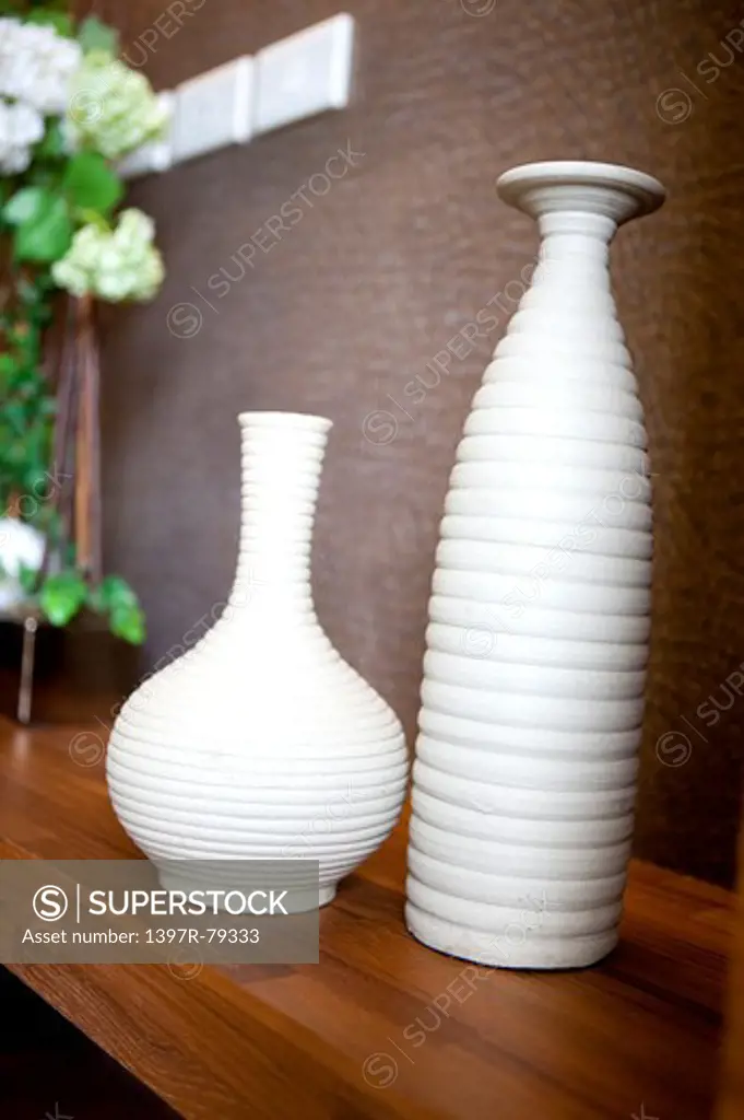 Close-up of two white vases