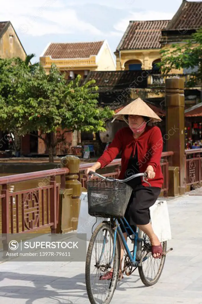 Vietnamese woman on bicycle,Vietnam,Asia