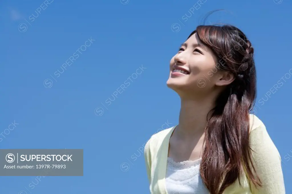 Young woman looking up with smile