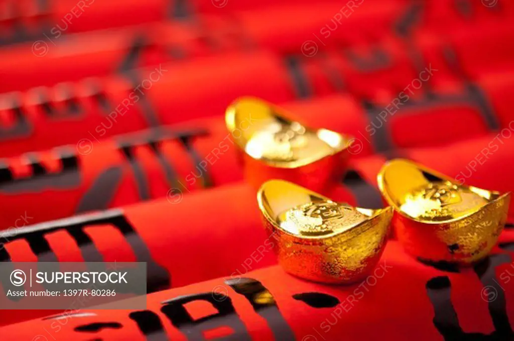 Close-up of gold ingots on Chinese scripts