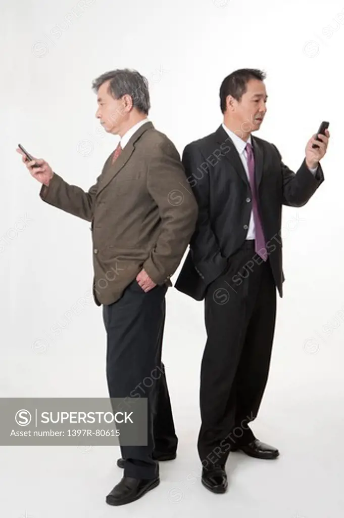Business men standing and holding mobile phone
