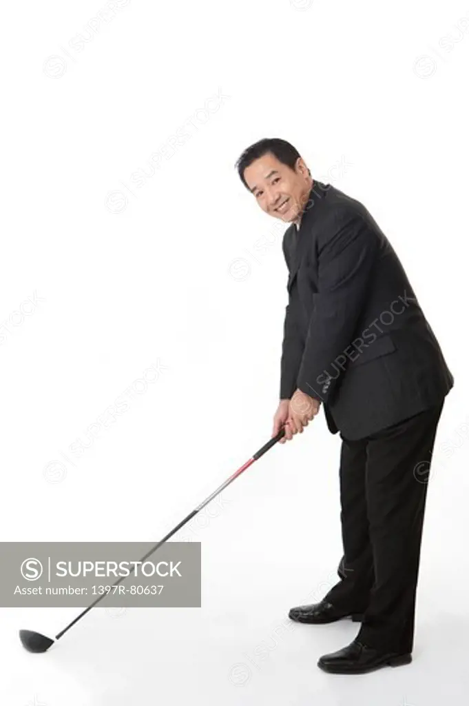 Business man holding golf swing and smiling at the camera