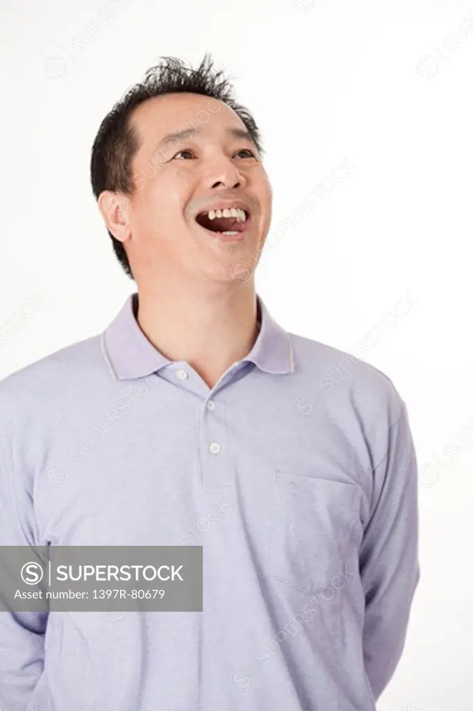 Mature man looking up and smiling happily
