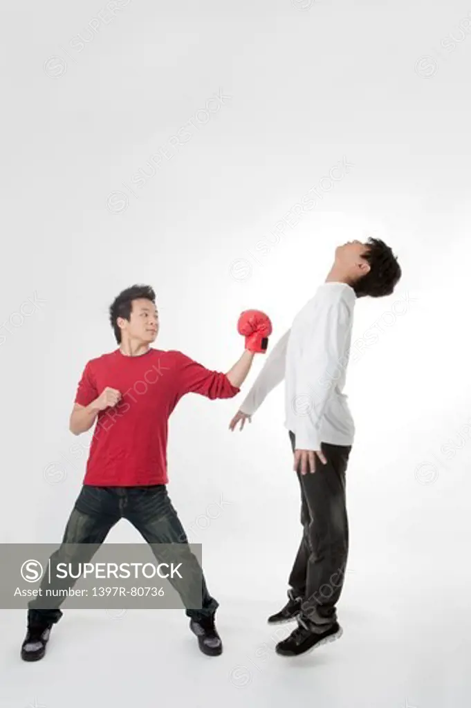 Teenager boys playing with boxing glove