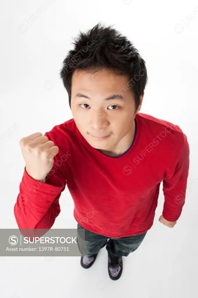 Teenage boy looking at the camera with fists up