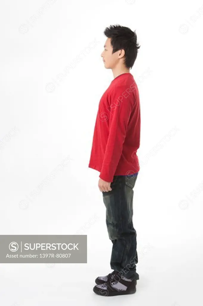 Teenage boy standing and looking away