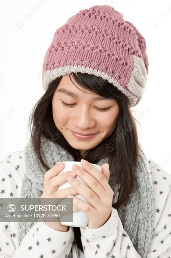 Young woman holding a cup with smile