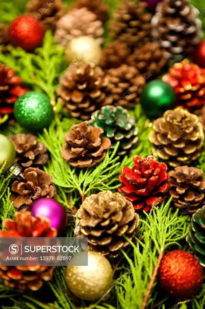 Close-up of Christmas ornaments and pine cones