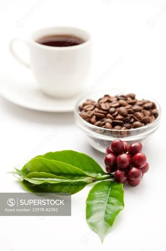 Close-up of coffee beans and a cup of coffee