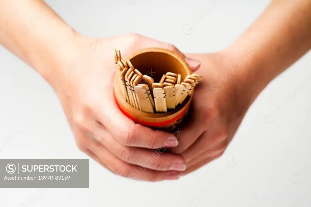Close-up of human hands holding lot pot