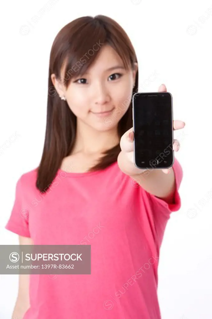 Beautiful young woman showing a mobile phone