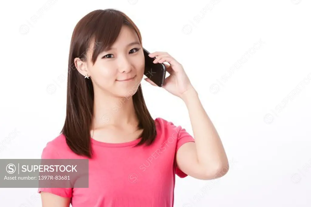 Beautiful young woman talking on mobile phone, smiling