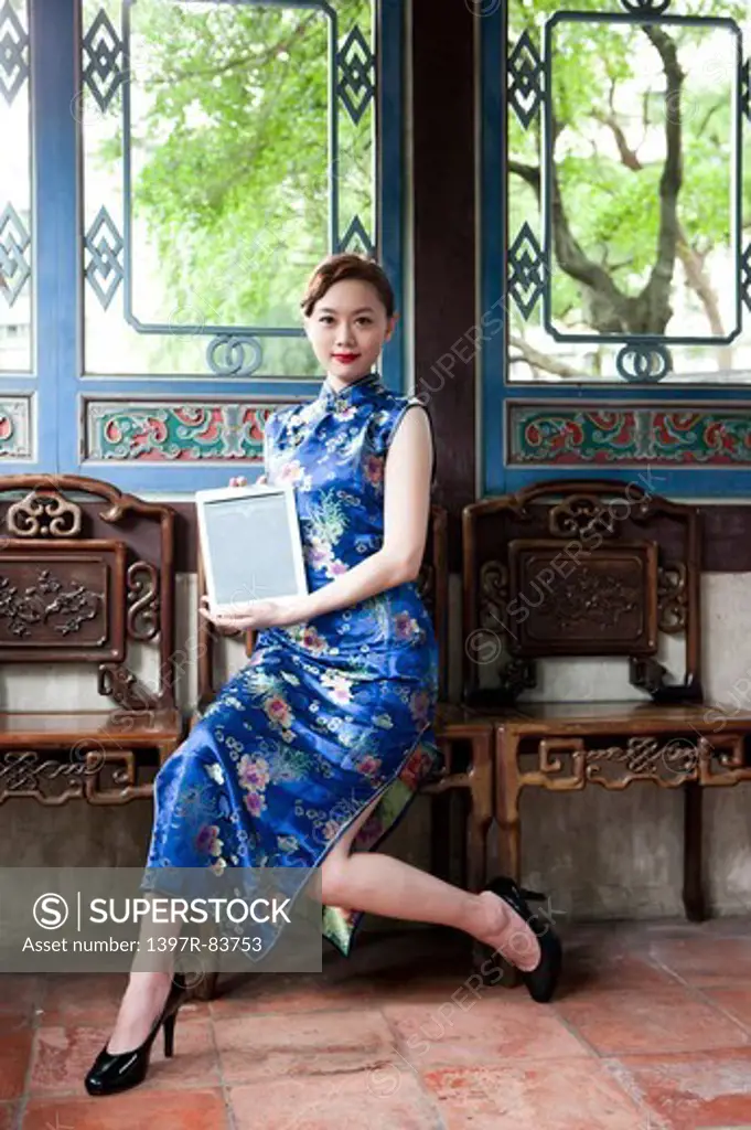 Young woman wearing cheongsam and looking away