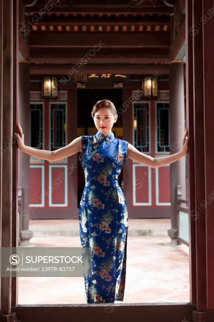 Young woman with cheongsam and standing with smile