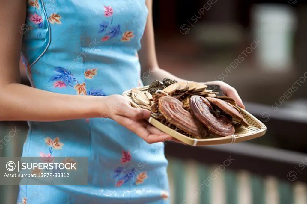 Young woman with cheongsam holding food