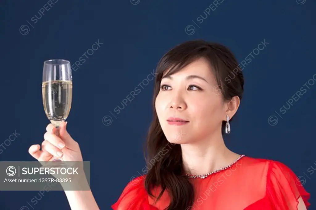Mature woman holding wineglass and looking away