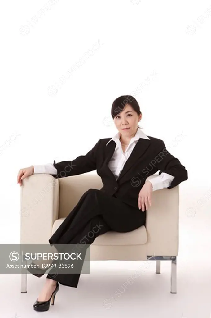 Businesswoman sitting on sofa and smiling at the camera