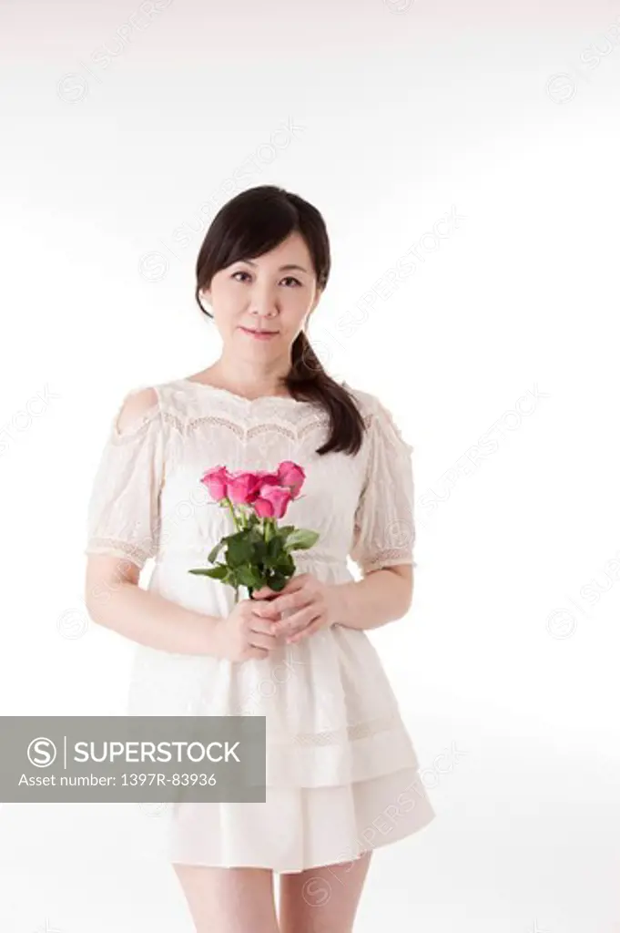Mature woman holding a bunch of flowers with smile