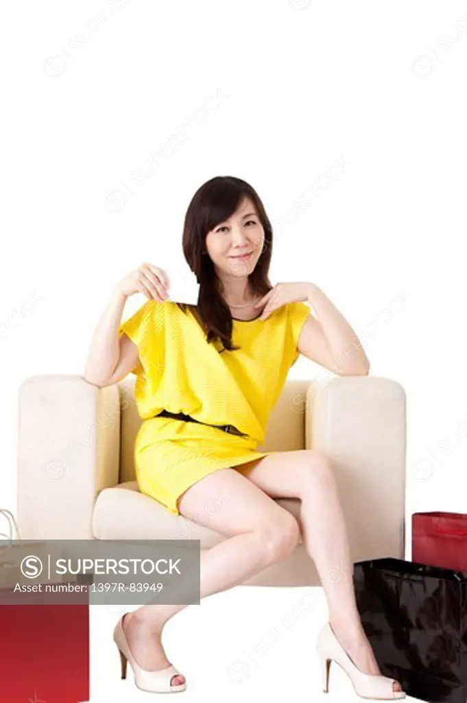Mature woman sitting on sofa and smiling at the camera