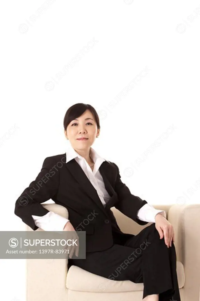 Businesswoman sitting on sofa and smiling at the camera