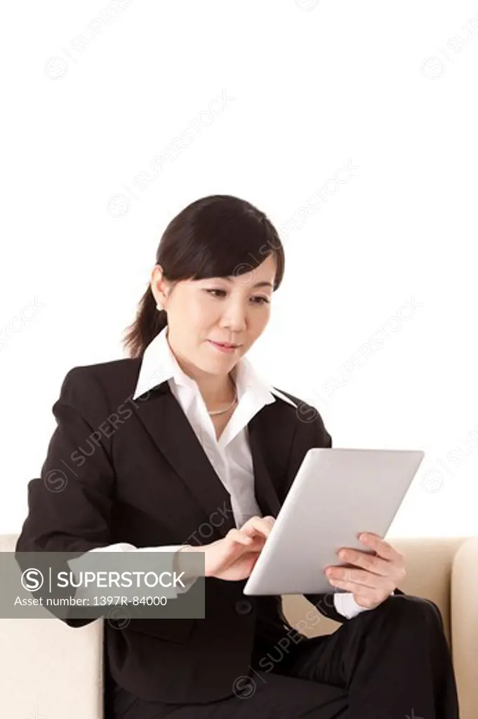 Businesswoman holding pad and looking down with smile