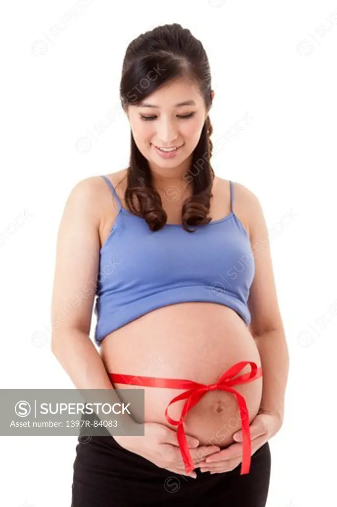 Woman holding abdomen with smile