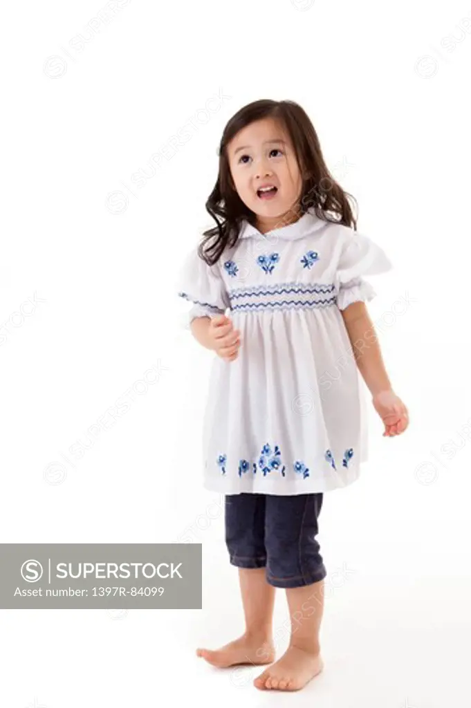 Little girl standing and looking away with smile