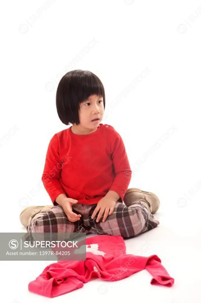 Girl sitting on the floor and looking away