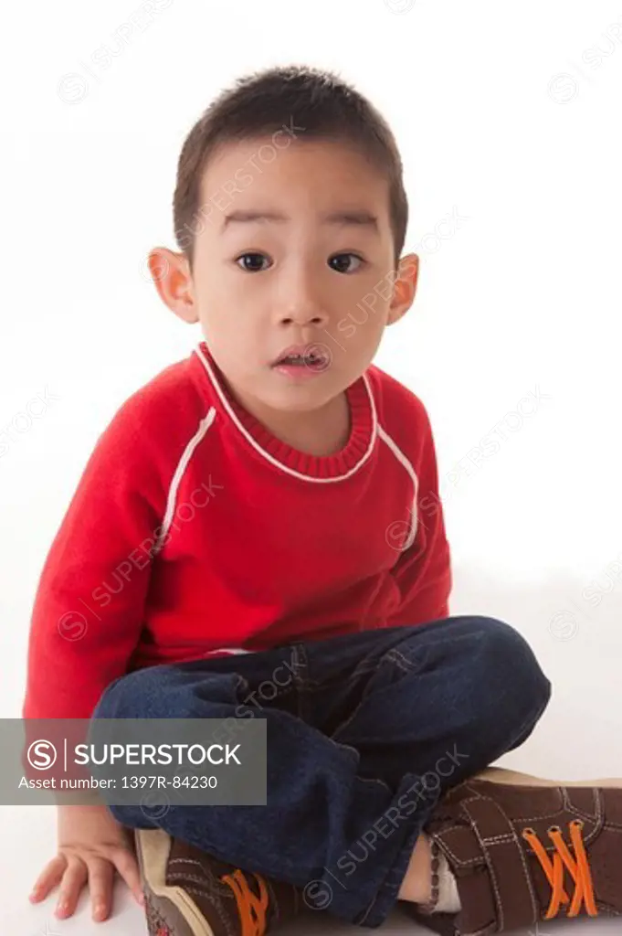 One boy sitting and looking away