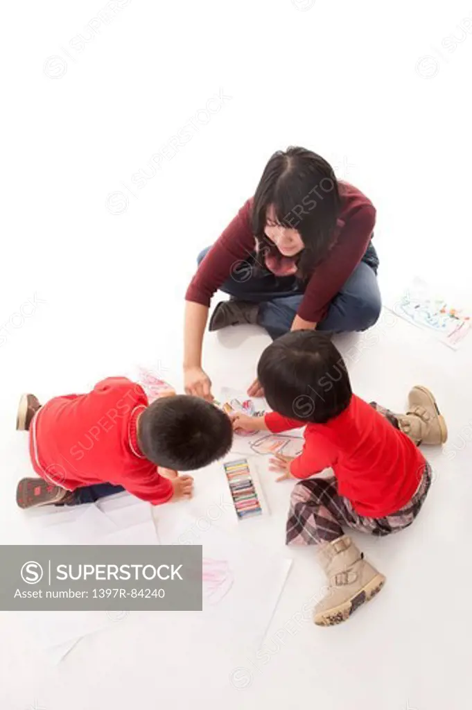 Family with two children drawing together