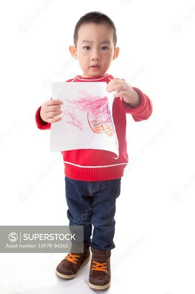 Boy standing and holding painting