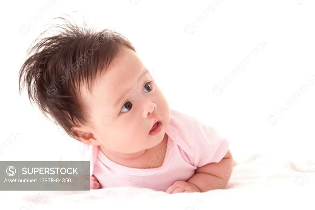 Baby girl crawling in bed