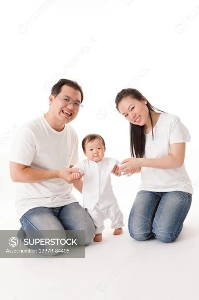 Family with one child holding hands and smiling at the camera