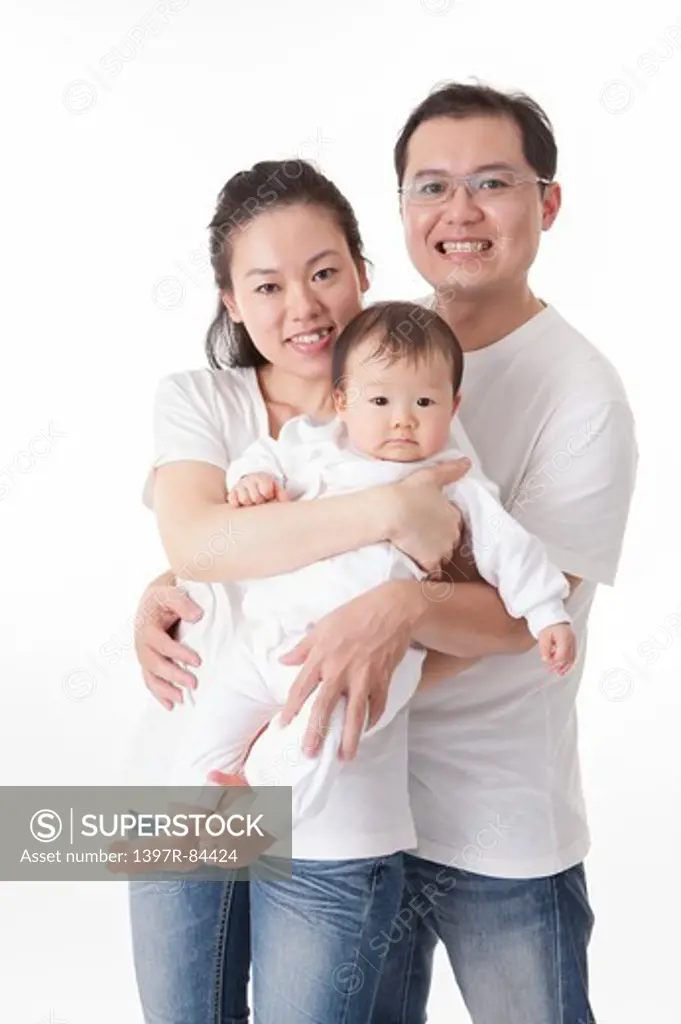 Family with one child smiling at the camera