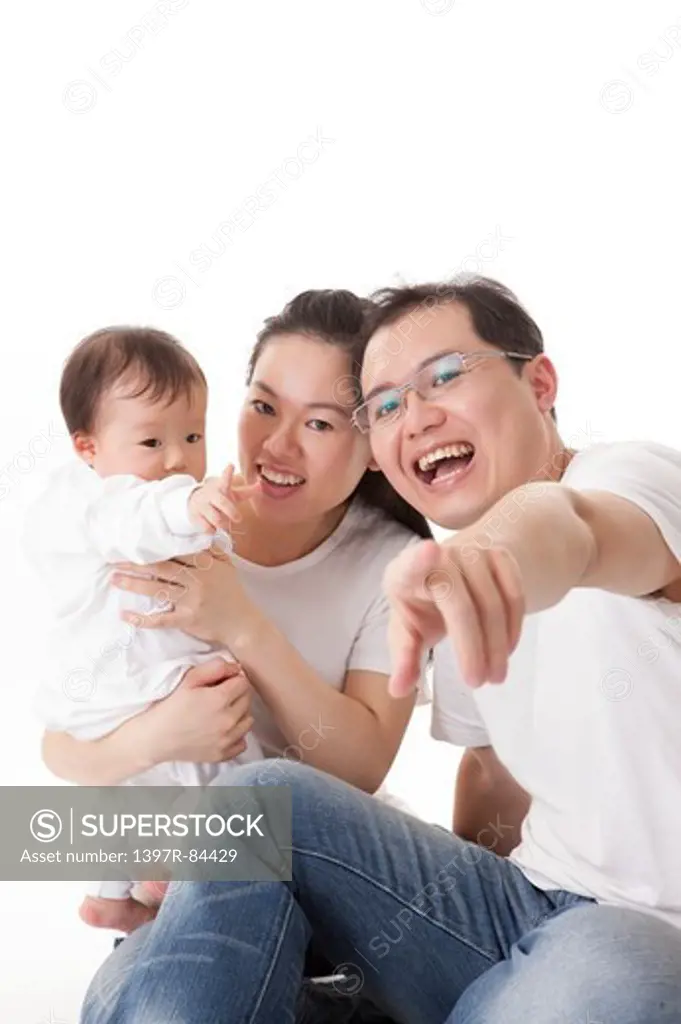 Family with one child smiling happily at the camera together