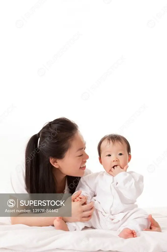 Mother holding baby girl with smile