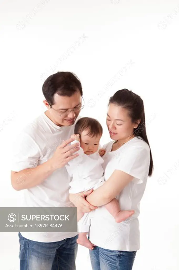 Family with one child holding baby girl