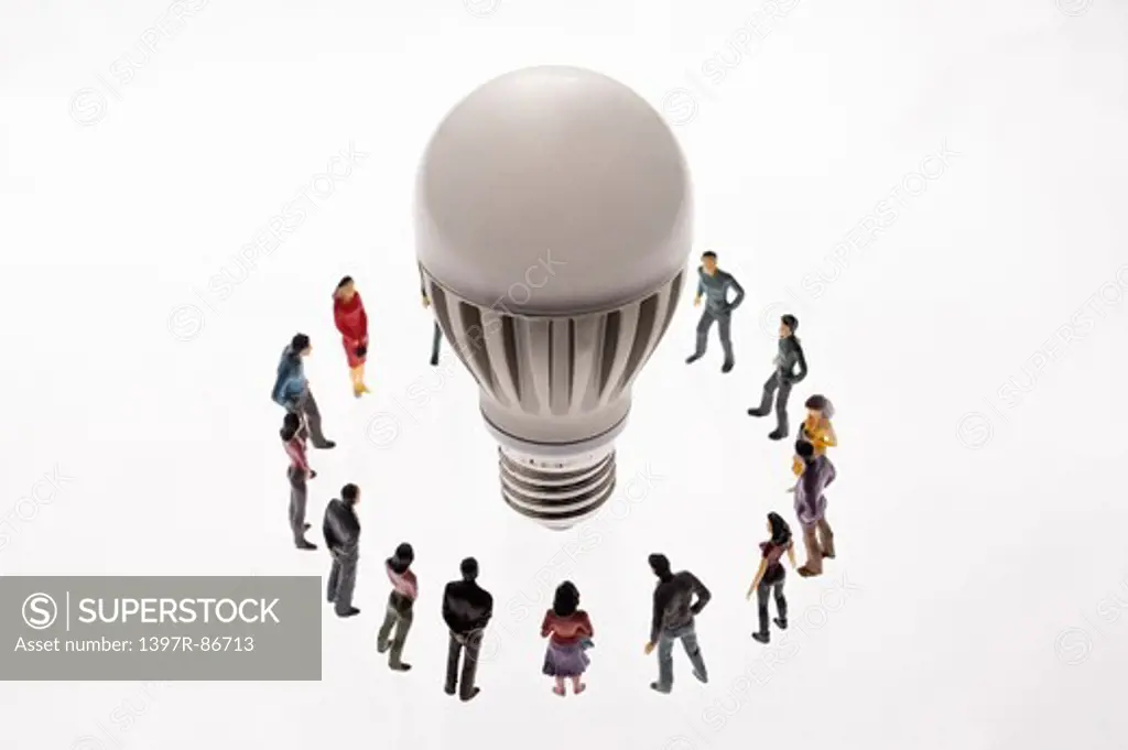 Light bulb surrounded by figurines