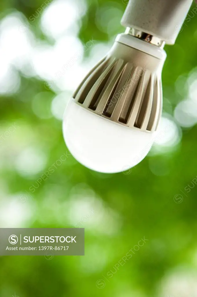 Light bulb on green defocused background