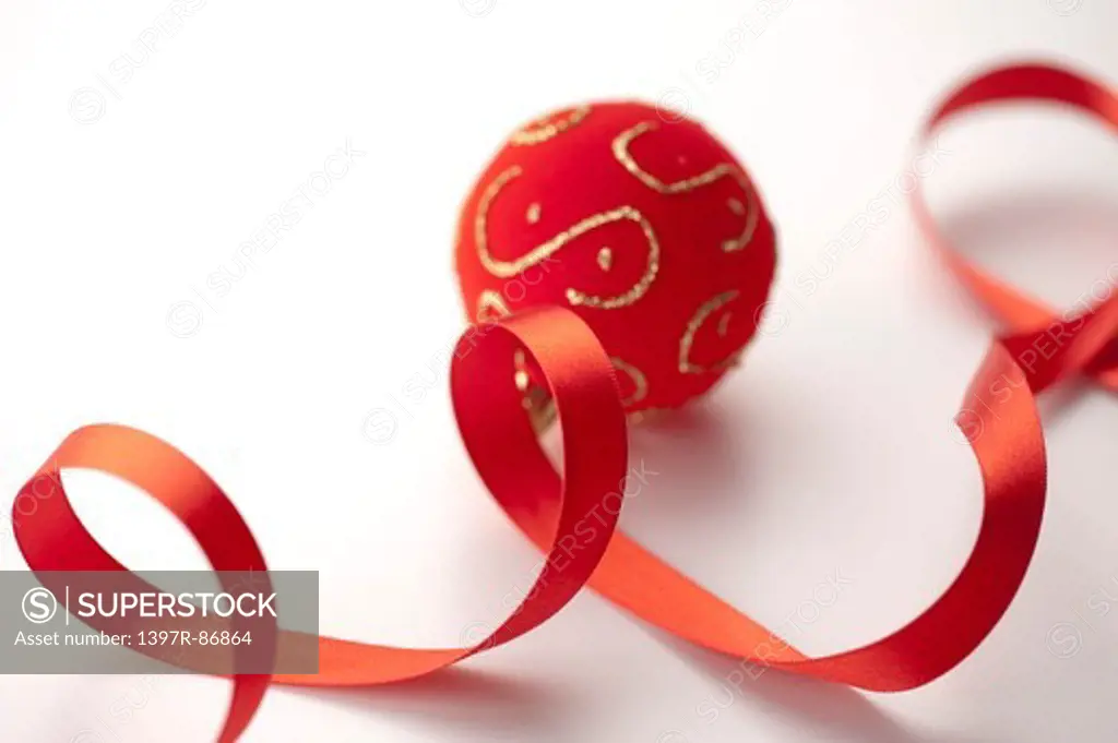 Decorative ball and curled red ribbon