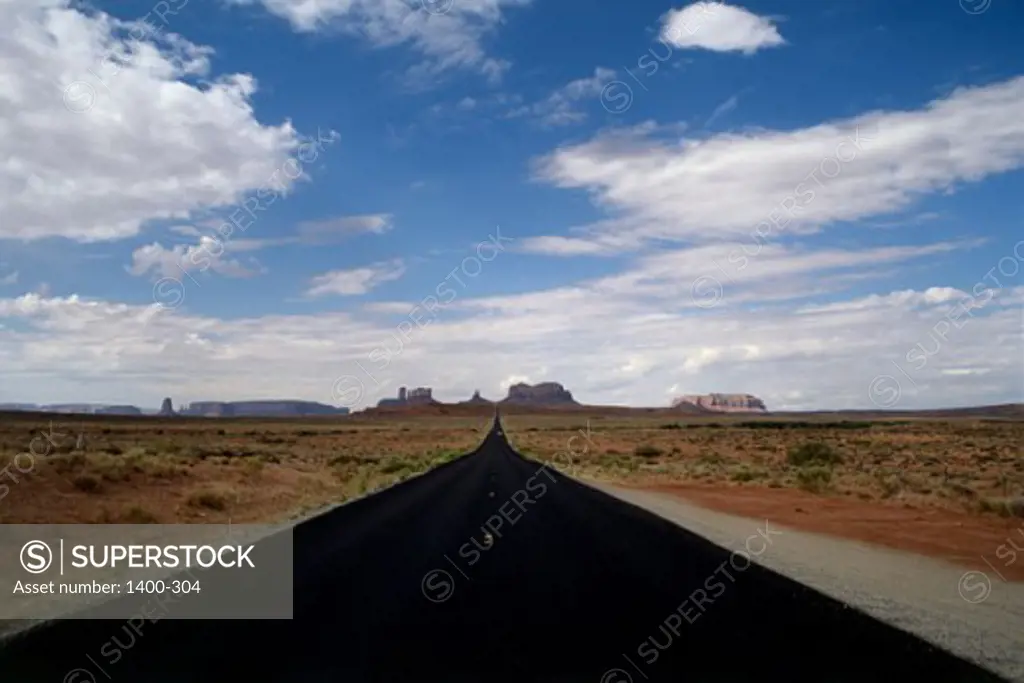 Road passing through an arid landscape, Monument Valley, Arizona, USA