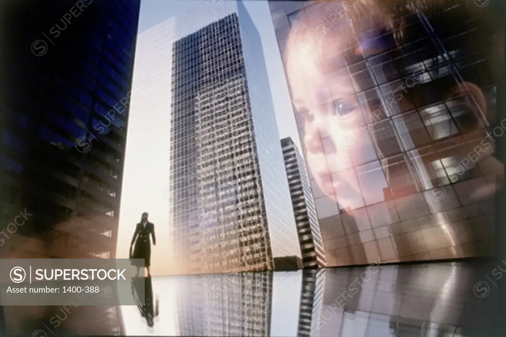 Baby's image superimposed on a skyscraper and a woman standing near it