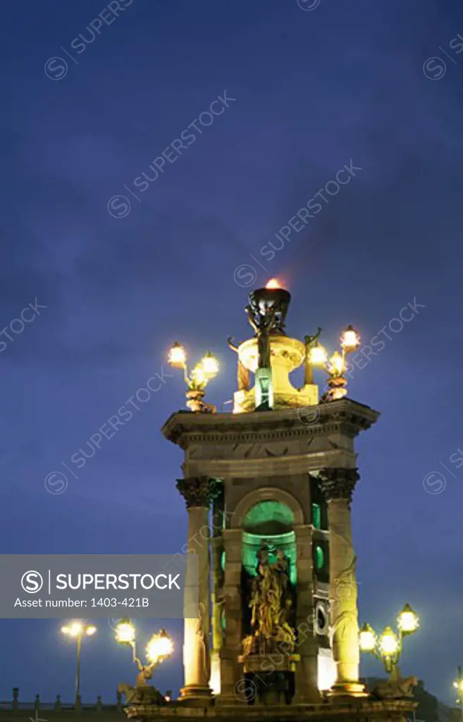 Monument lit up at dusk, Plaza De Espana, Barcelona, Spain